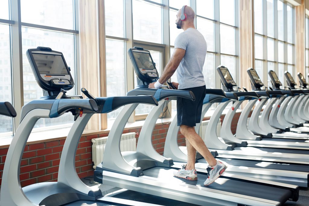 Personal Trainer running on treadmill